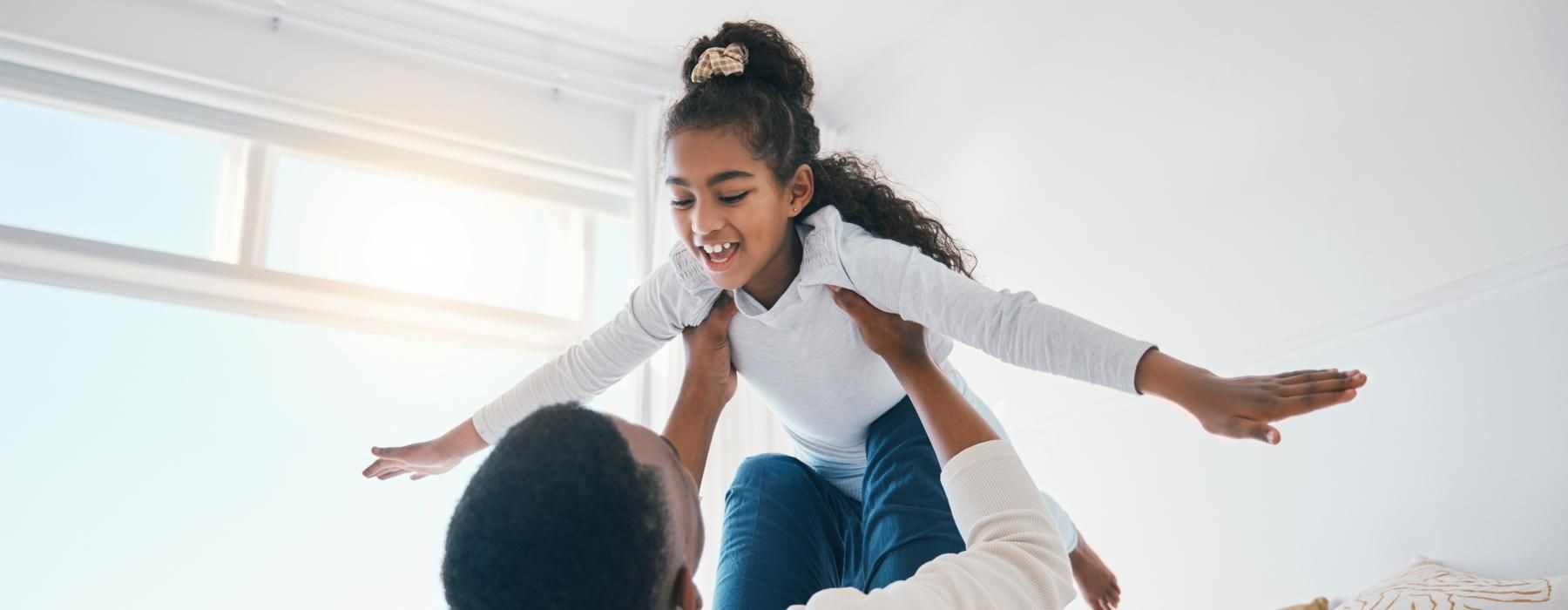 a man holding a child in the air