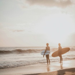 two people walking along the beach